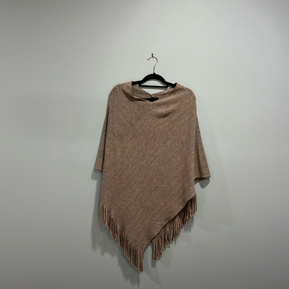 Knitted poncho color is  light Pink in pic looks more muted